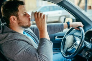 man distracted while driving - dangers of distracted driving in florida - viles and beckman - fort myers