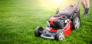 man-using-modern-lawnmower-on-grass