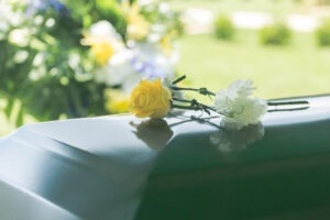 wrongful-death-accident-personal injury-flowers-funeral-casket-outdoors