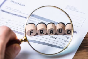a magnifying-glass-reveals-fraud-in-an-invoice
