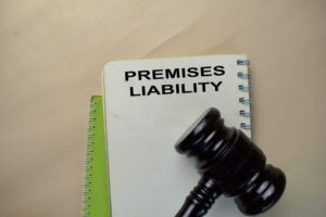A close-up of gavel and a notepad with “premises liability” written on it.