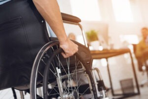 A man in a wheelchair after a car accident that caused a permanent disability.