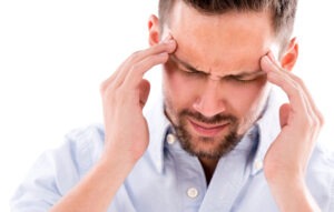 A man with a headache holding his head after a Florida car accident