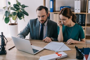 A wrongful death lawyer explaining his role to a grieving client