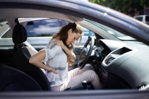 A woman is in pain after a car accident. What expenses are covered in a car accident settlement?
