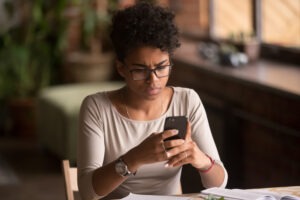 An upset woman contacts a premises liability lawyer after experiencing pain from a slip and fall accident.