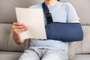 Injury victim reading a letter from the insurance company. Learn if you can negotiate with the insurance company after a truck accident.
