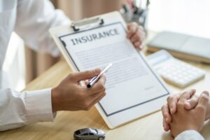 A person explaining how insurance coverage affects compensation for truck accidents.