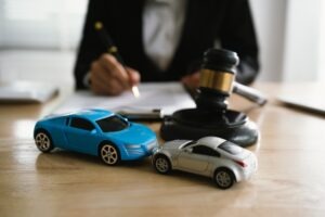 A car accident attorney sitting at a desk. You can learn what a no-win, no-fee car accident lawyer is today.