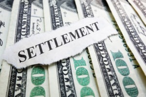 Settlement newsclipping and money. Learn what is considered when calculating a settlement for a truck accident case.