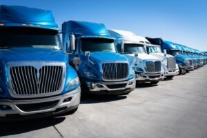 A line of commercial vehicles. A lawyer can tell you what types of insurance are involved in truck accident claims.