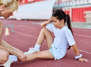 A little girl is injured at a stadium and an adult is helping her, wondering what are my child’s legal rights after an injury