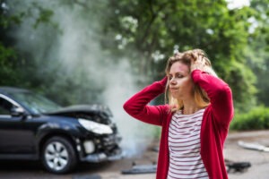 Woman after car accident. Learn when you should hire a lawyer after a car accident.